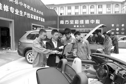 大英縣中等職業學校通過“引企入?！?，將企業維修中心建到了校園內，圖為企業專業技師向學生講解高檔轎車的保養維修技巧。